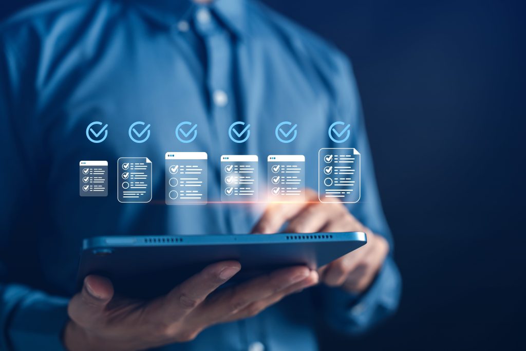 Businessman holding an ipad with compliance documents hovering above